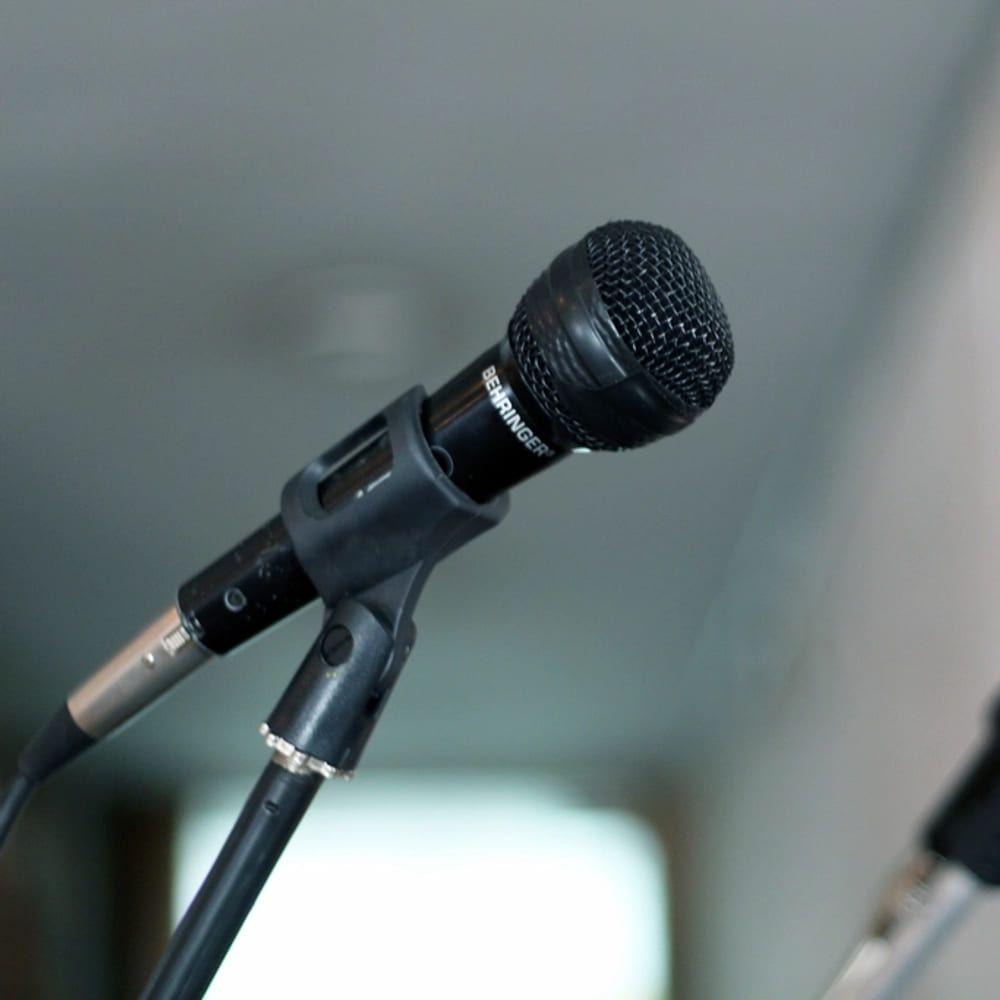 A microphone on a stand in a bright room